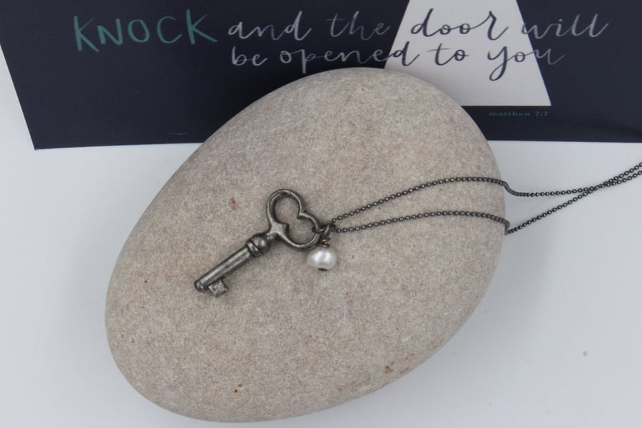 Antique key and pearl necklace with scripture postcard