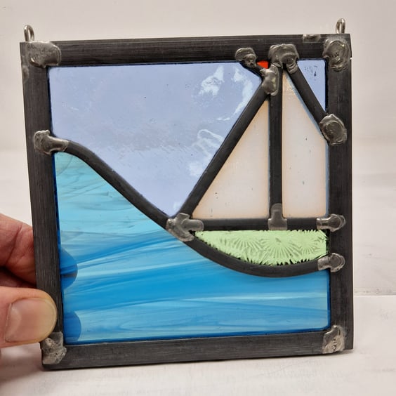 Stained glass pale green sailing boat and wave leaded hanging panel.