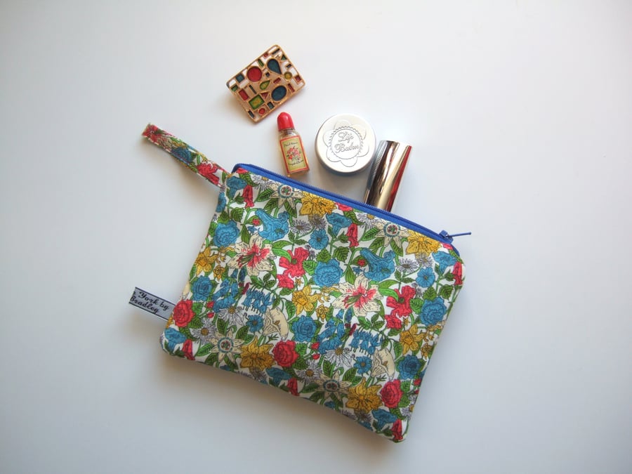 Liberty print purse, makeup or cosmetics bag, with bright floral design.