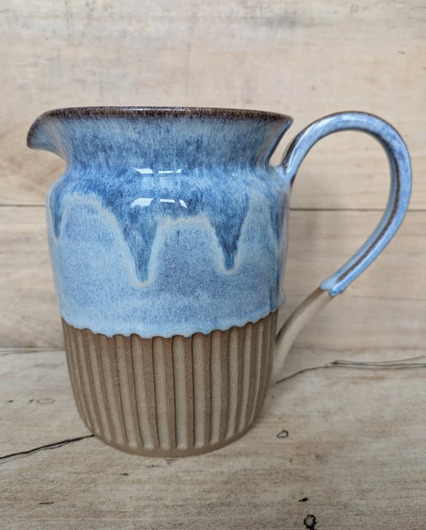 Larger pale blue carved jug (straight shoulder)