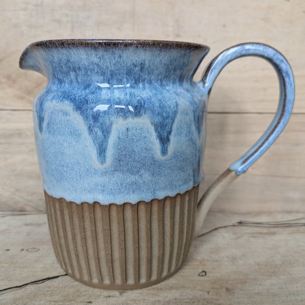 Larger pale blue carved jug (straight shoulder)