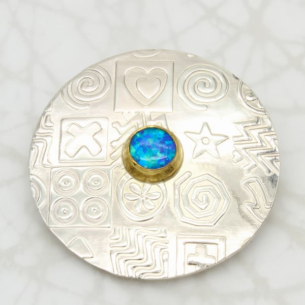 Contemporary round sterling silver brooch featuring a blue Opal, gemstone choice