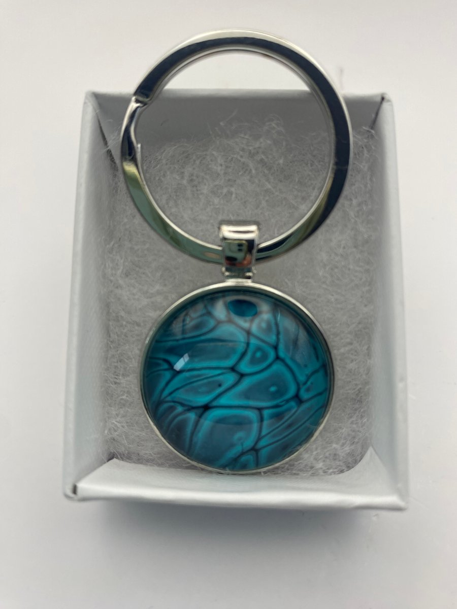 Key ring with acrylic fluid art pendant in silver coloured setting 