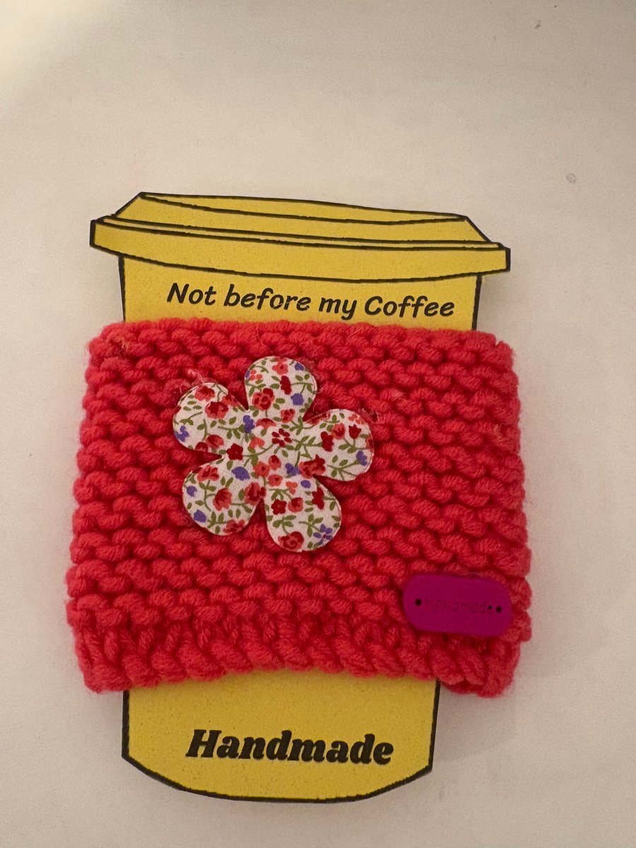 Flower knitted cup cosy. 