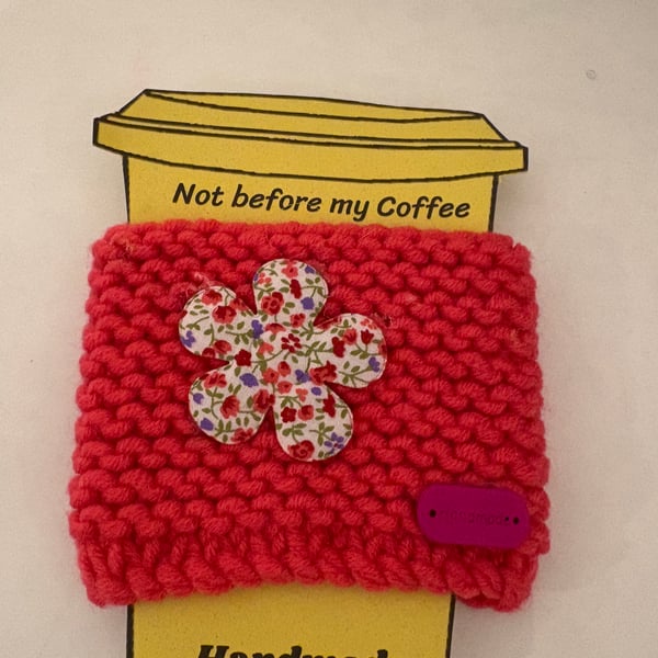 Flower knitted cup cosy. 