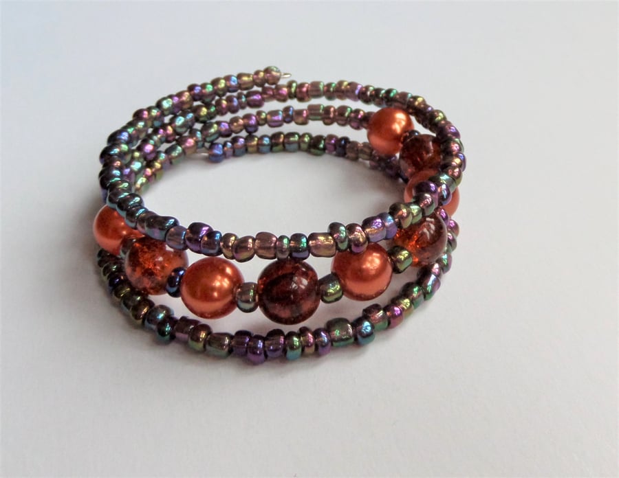 Orange glass and acrylic bead and metallic rainbow seed bead wrap bracelet