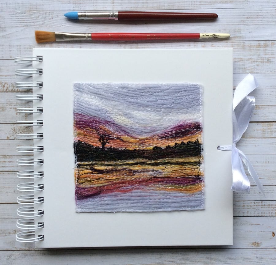 Embroidered sunset sketchbook, journal or scrapbook. 