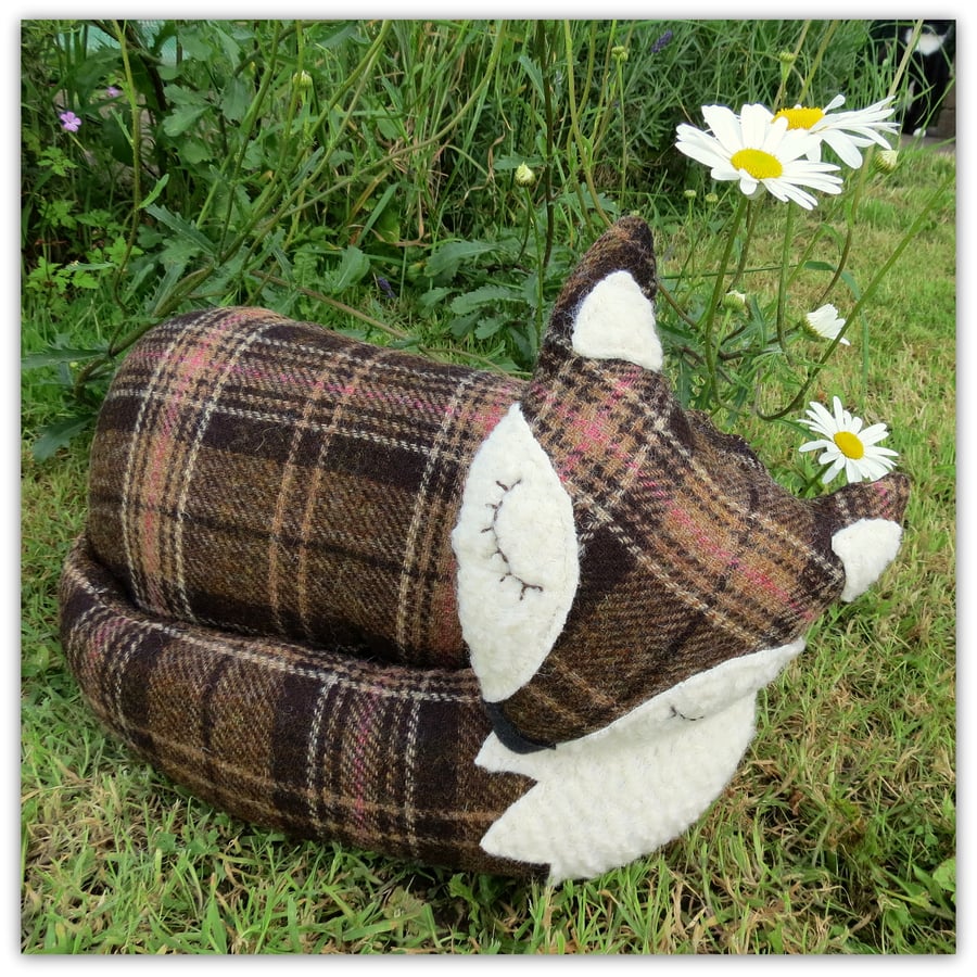   A large snoozy fox cushion in tartan wool. 38cm in length.