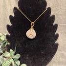 Beautiful wire wrapped grey pebble pendant on gold coloured chain. 