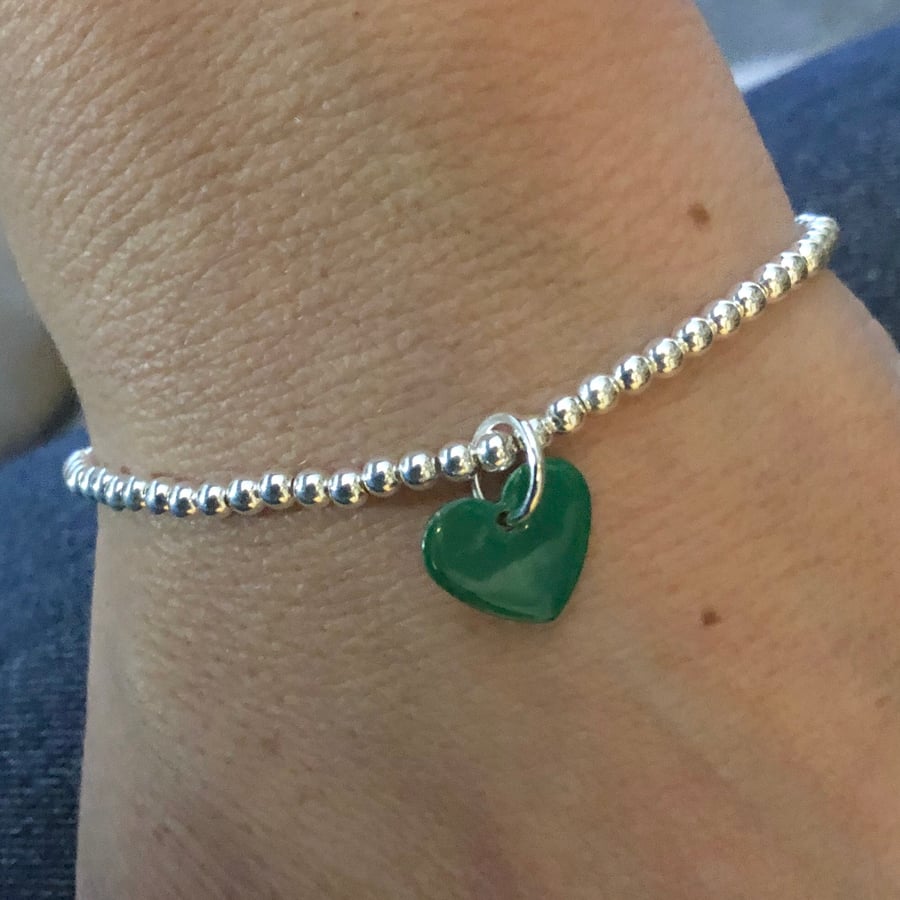Green enamel heart on silver beaded stretch bracelet. Stacking bracelet.
