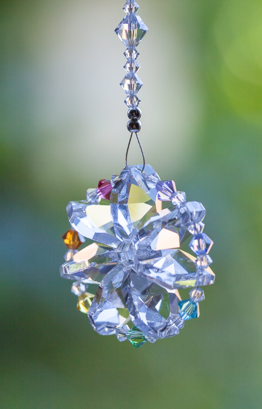 Sun-catcher in rainbow chakra colours.