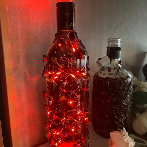 Upcycled bottle Stranger things with alphabet and red lights 