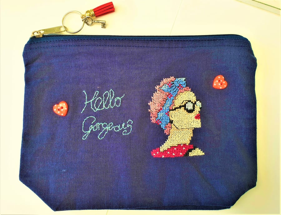 Small zip up navy bag handstitched with 50s rockabilly theme lady