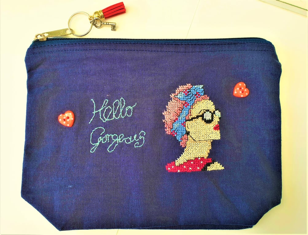 Small zip up navy bag handstitched with 50s rockabilly theme lady