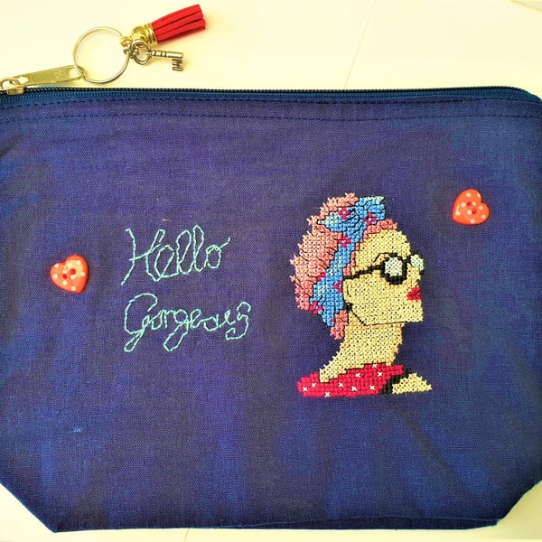 Small zip up navy bag handstitched with 50s rockabilly theme lady