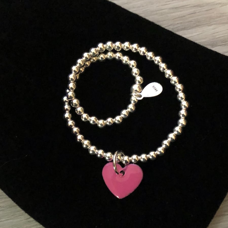 Pink enamel heart in sterling silver beaded stretch bracelet. Stacking bracelet.