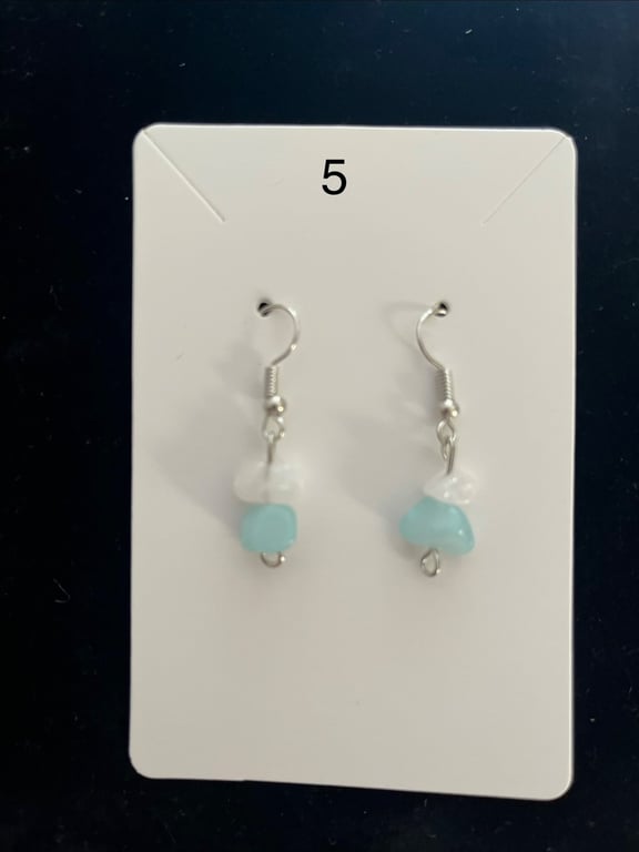 Beautiful dangling earrings with white and turquoise stones.