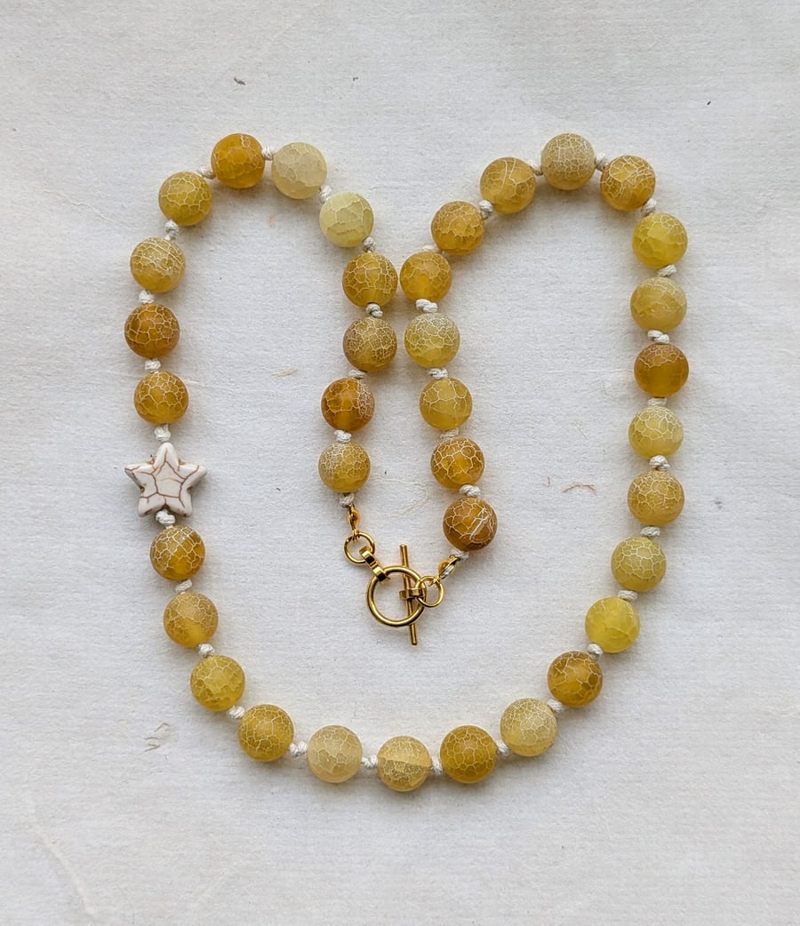 Butter yellow frosted agate bead and howlite star knotted cord necklace 