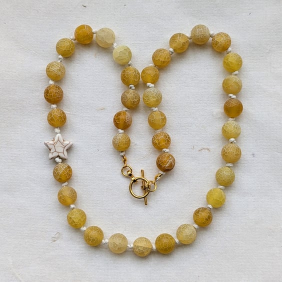 Butter yellow frosted agate bead and howlite star knotted cord necklace 