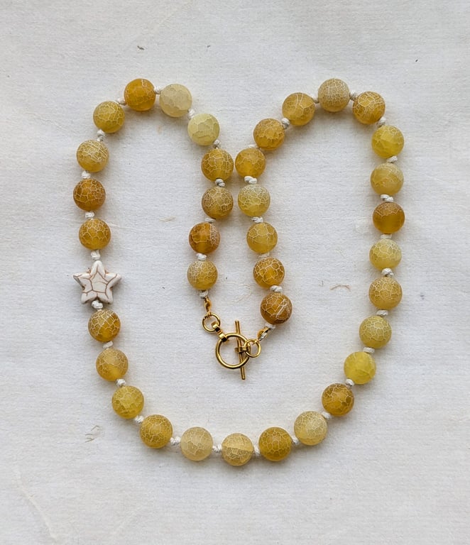 Butter yellow frosted agate bead and howlite star knotted cord necklace 