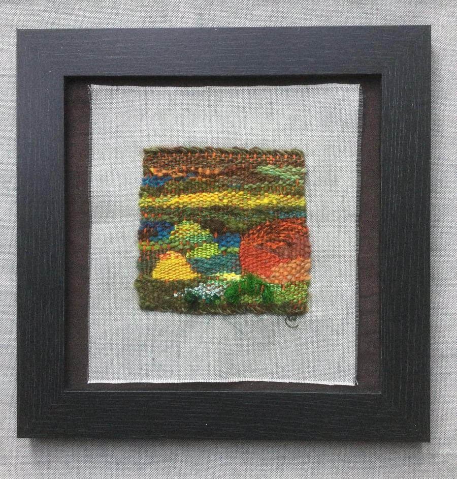 Framed handwoven tapestry weaving, textile art in green, yellow and orange