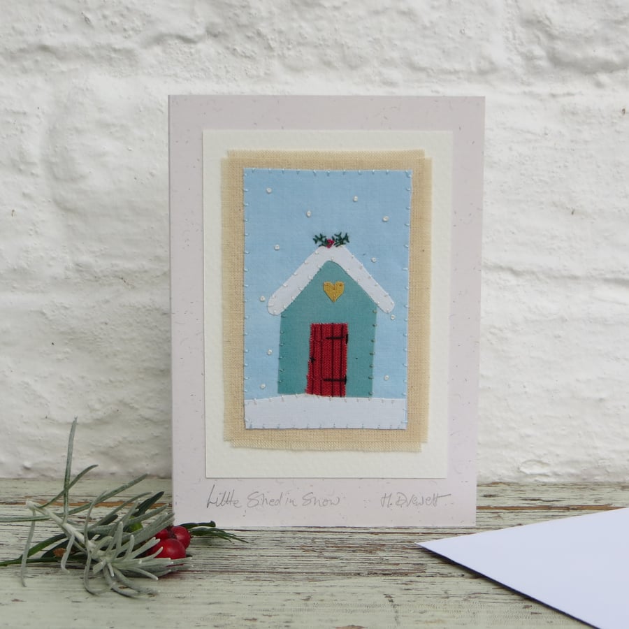 Sweet little hand-stitched shed in snow Christmas card