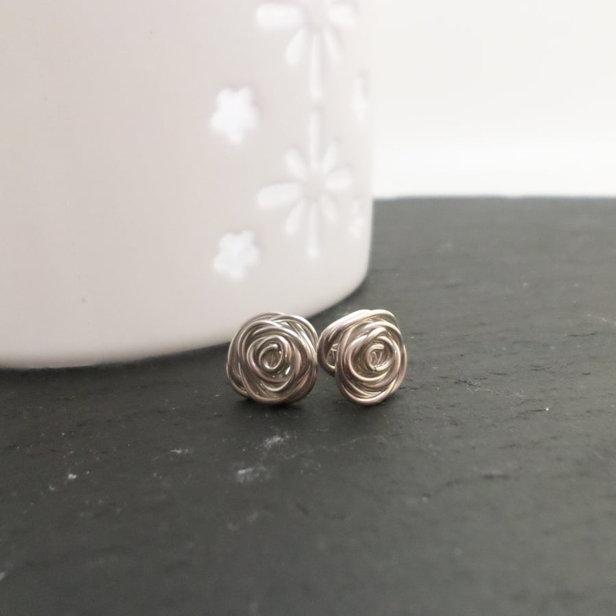 Sterling silver rose shaped stud earrings.