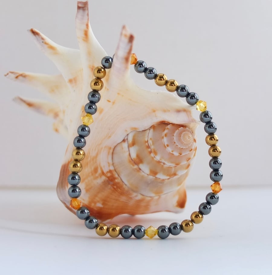Golden and Gunmetal Hematite Bracelet with "Topaz" Swarovski Crystals.
