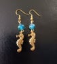 Gold stainless steel seahorse charm dangle earrings with blue beads 