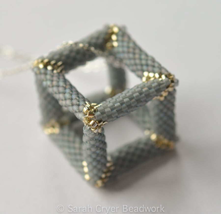 Pale blue and silver hollow beadwoven cube pendant