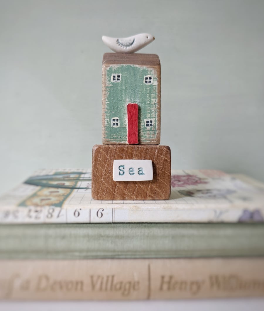 Little wooden house with clay bird 'sea'