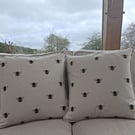 Pair of cushions with bee pattern front