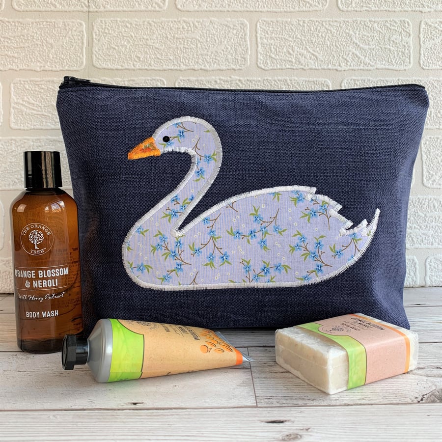 Dark blue toiletry bag with white and blue floral swan