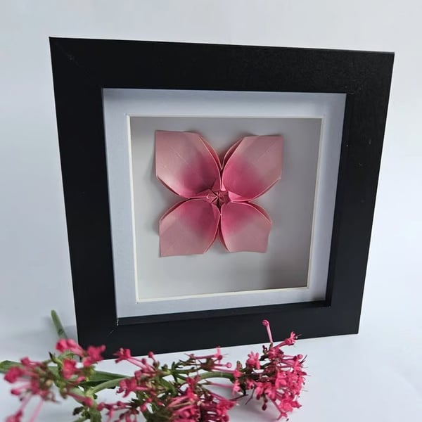 Pink origami flower in a shadow box frame