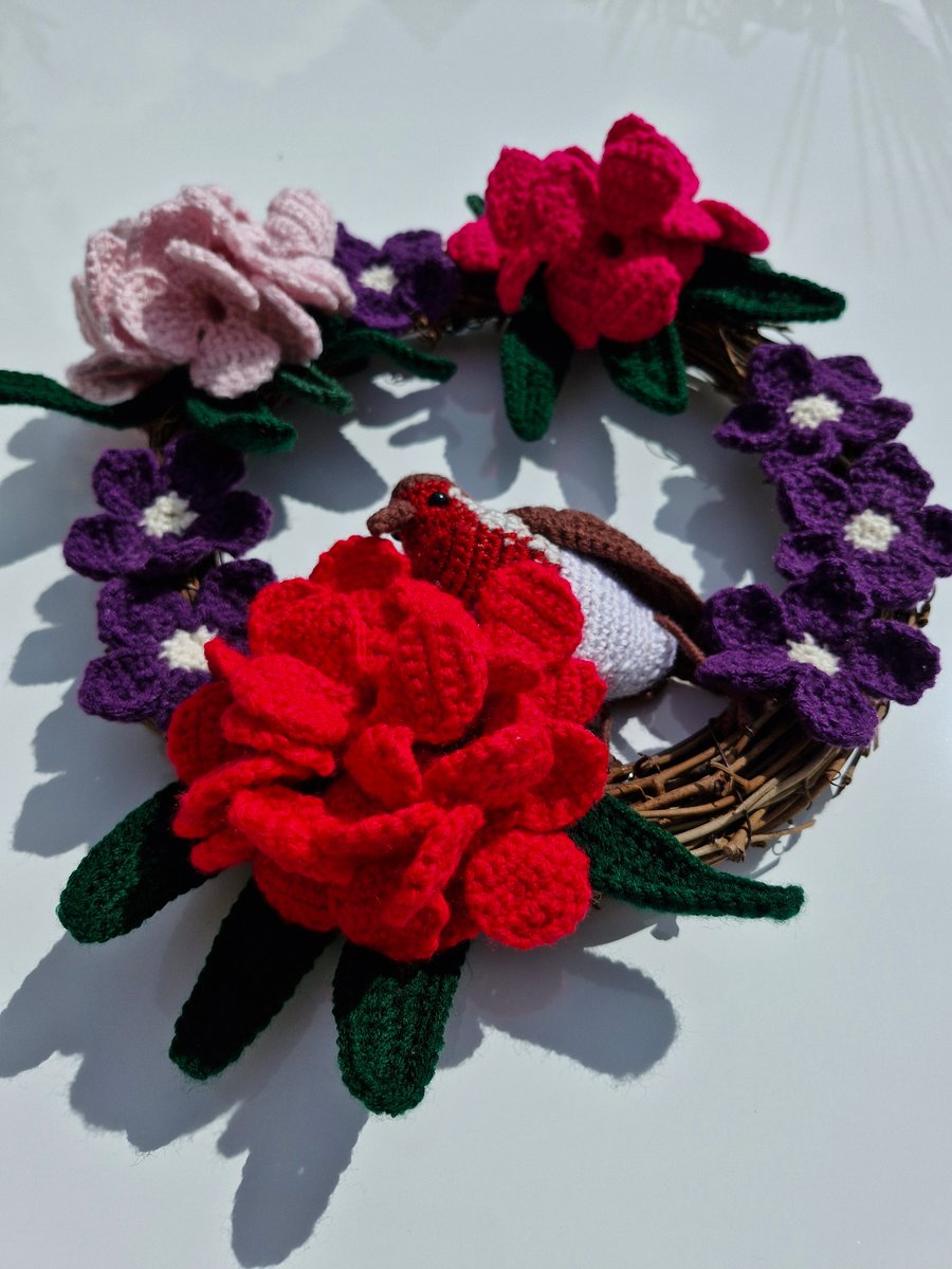  Crocheted rhododendron  flowers and a robin adorn a 25cm rattan wreath base.