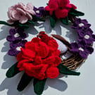  Crocheted rhododendron  flowers and a robin adorn a 25cm rattan wreath base.