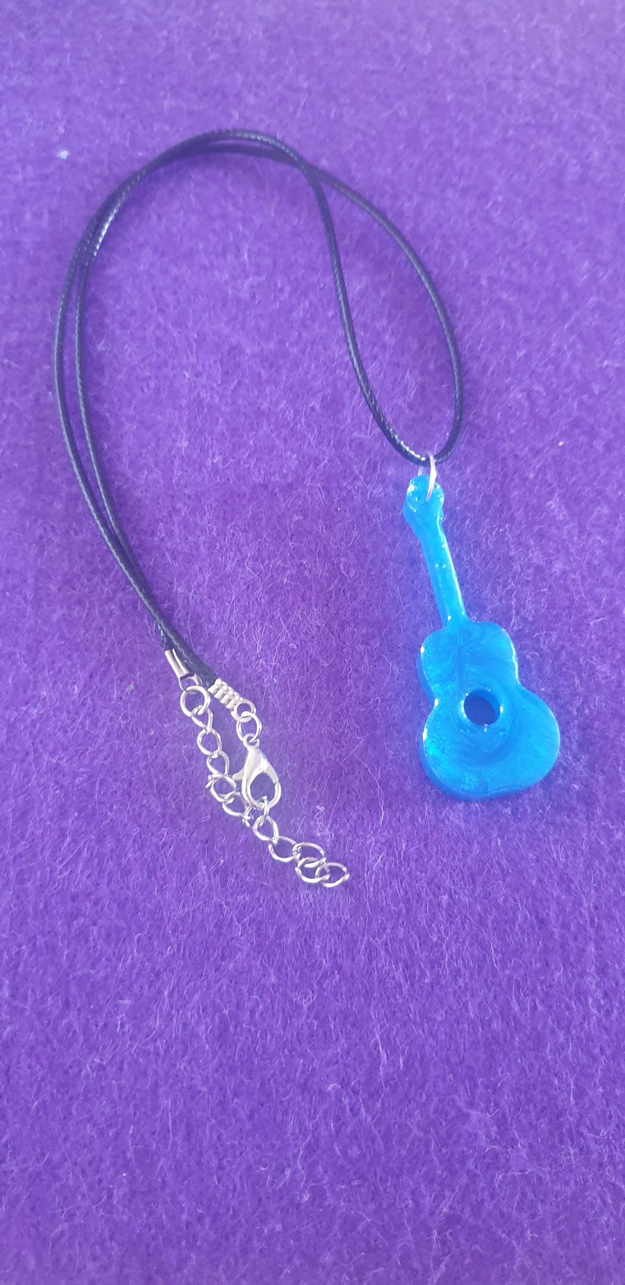 Blue guitar pendant on black cord necklace