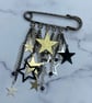 Starry kilt pin brooch with star charms and spinel stones