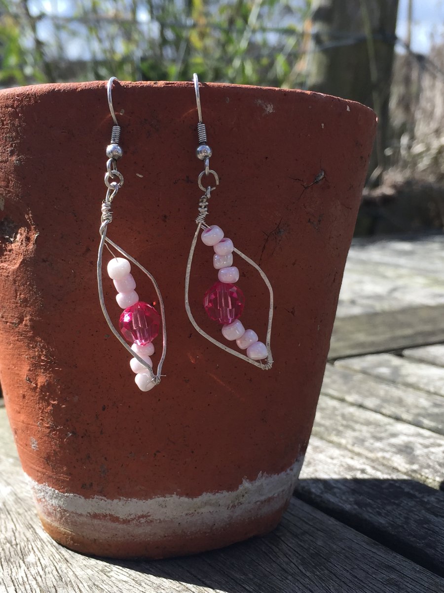 Pink beaded earrings in metal leaf shape wire