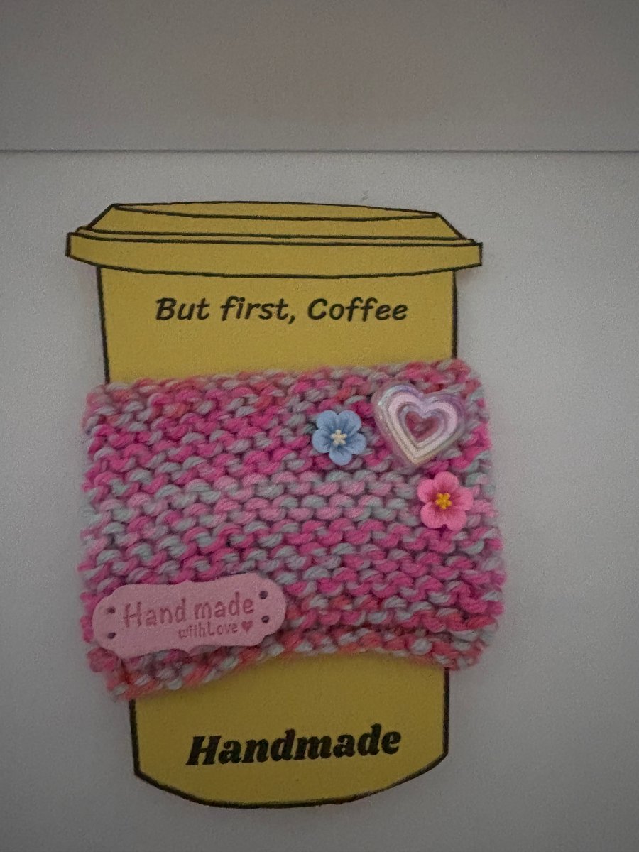 Pink heart and flowers knitted cup cosy. 