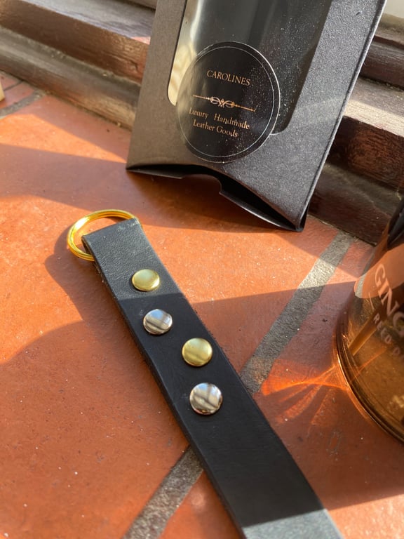 Keyring or bag charm Black leather and gold and silver metal studs