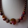 RICH REDS AND BROWNS CHUNKY NECKLACE.  679