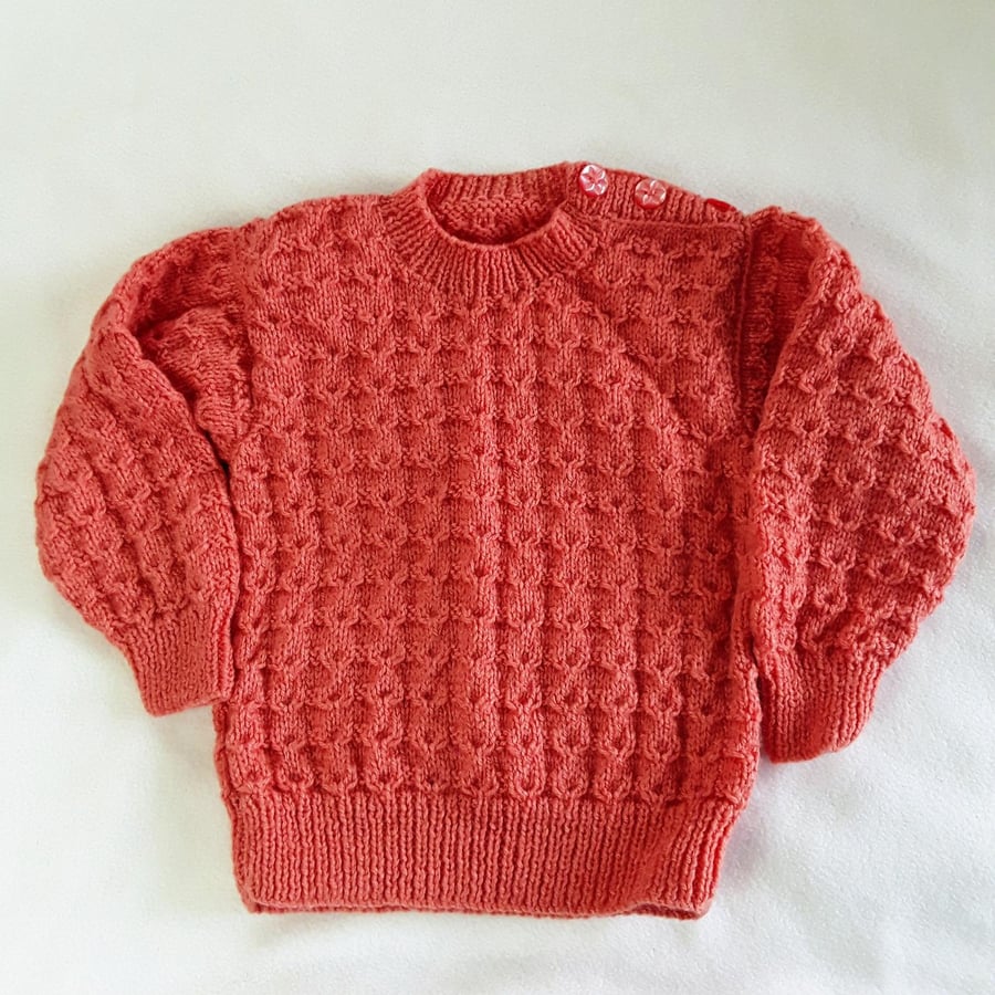Hand knitted baby girl jumper in deep pink to fit 12-18 months