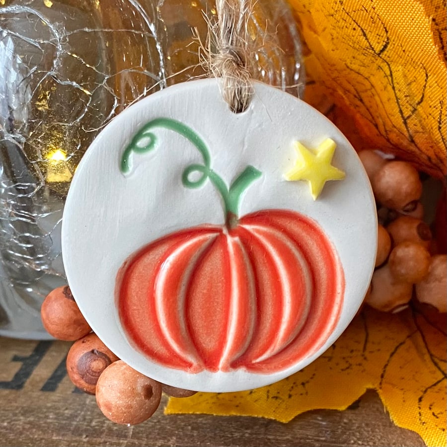 Small ceramic pumpkin decoration with star