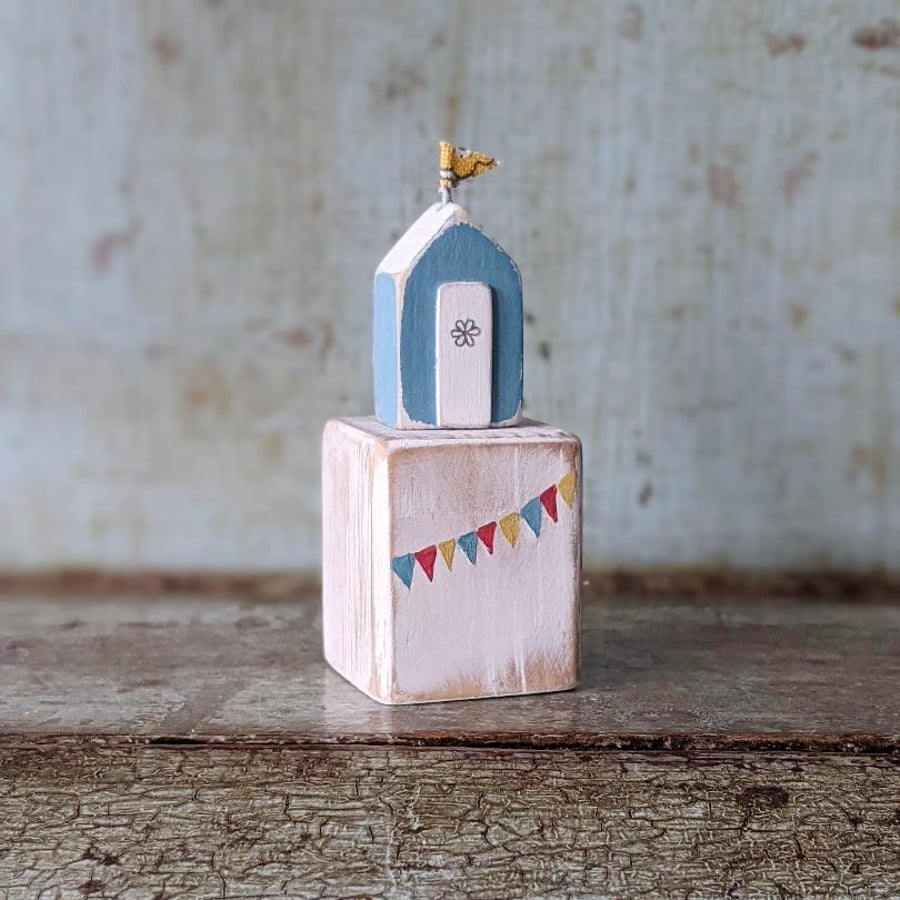Tiny Beach Hut on a Wooden Block with Bunting