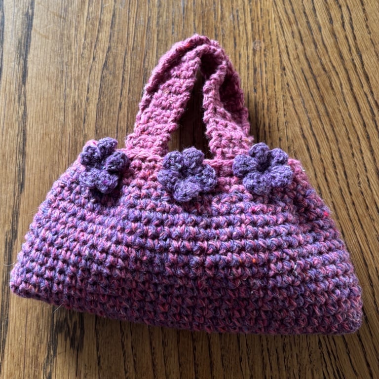 Small pink and purple crochet stash bag with flowers