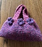 Small pink and purple crochet stash bag with flowers