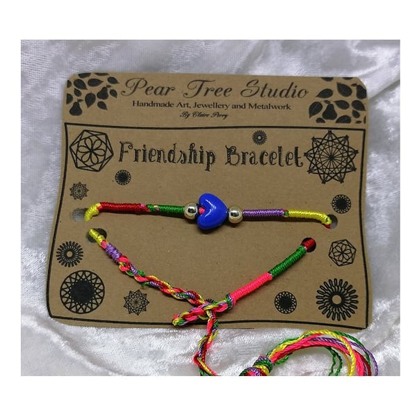 Friendship bracelet with dark blue heart bead.