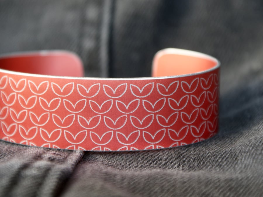 Leaf pattern aluminium cuff orangey red