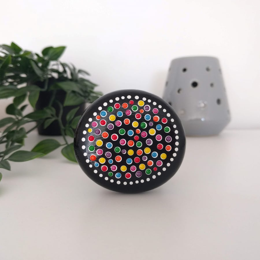 Colourful dot painted wooden pebble